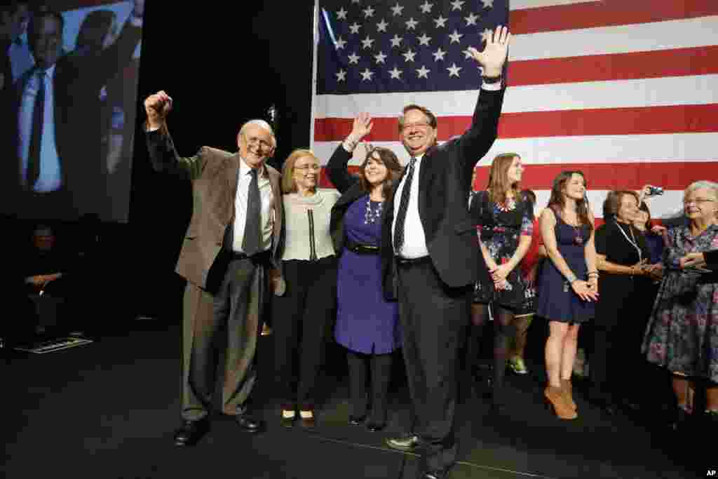 U.S. Senate-elect Gary Peters (D-MI) stands with his wife Colleen (center), retiring Sen. Carl Levin, Levin's wife Barbara Halpern-Levin after Gary Peters addressed supporters in Detroit, Michigan, Nov. 4, 2014.