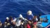 FILE - Migrants in a dinghy are rescued by the Libyan coast guard in the Mediterranean Sea off the coast of Libya, Oct. 18, 2019. 