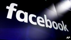 FILE - This March 29, 2018, photo shows the logo for Facebook on screens at the Nasdaq MarketSite, in New York's Times Square.