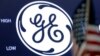 FILE - The General Electric logo appears above a trading post on the floor of the New York Stock Exchange, June 26, 2018. 