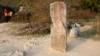 FILE - Chinese business women walk near old border marker 53 between China's Guangxi and Vietnam's Cao Bang province.