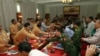 Members of Myanmar government negotiators, right, shake hands with representatives of the Shan State Army (SSA).