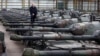 Freddy Versluys, the CEO of Belgian defense company OIP Land Systems, stands among dozens of German-made Leopard 1 tanks, in a hangar in Tournais, Belgium, Jan. 31, 2023.