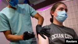 FILE - Sean Bagley, 14, receives the Pfizer-BioNTech COVID-19 booster vaccine targeting BA.4 and BA.5 Omicron subvariants at Skippack Pharmacy in Schwenksville, Pennsylvania, Sept. 8, 2022. 