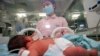 FILE - A nurse takes care of a newborn baby at a hospital in Taizhou in China's eastern Zhejiang province on May 12, 2022.