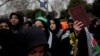 A woman holds a copy of the Quran during a protest in Istanbul, Turkey, Jan. 29, 2023, following the burning of the Quran in Stockholm.