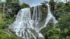 Visitors must jump between slippery rocks to reach the view from the top of Tabouna Falls in Guinea. It's the kind of tropical paradise that tourists would flock to, but its tourism sector has not yet been developed. 