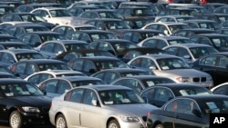 FILE - Imported German-made BMWs are parked at the North East Auto Terminal in Jersey City, New Jersey.