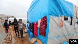 FILE - Children are seen at a displaced persons camp in Idlib province, Syria, Dec. 1, 2020.