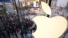 FILE - People line up to enter a newly opened Apple Store in Wangfujing shopping district in Beijing, Oct. 20, 2012.