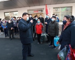 FILE - Chinese President Xi Jinping inspects the novel coronavirus prevention and control work at Anhuali Community in Beijing, China, Feb. 10, 2020.