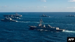 FILE - This handout photo taken by the U.S. Navy and released Jan. 18, 2024 by the Joint Staff Office of the Defense Ministry of Japan shows the US Navy USS Kidd following the USS Carl Vinson during maritime exercises with the navies of Japan and South Korea.