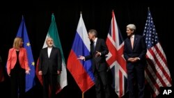 Menlu Inggris Philip Hammond (dua dari kanan), Menlu AS John Kerry (paling kanan), dan Perwakilan Tertinggi Uni Eropa untuk Kebijakan dan Keamanan Luar Negeri Federica Mogherini (kiri) dan Menlu Iran Mohammad Javad Zarif di Wina, Austria (Foto: dok). 