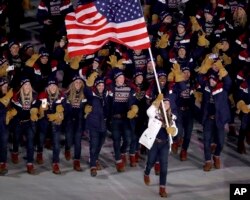 Erin Hamlin carries the flag of the United States during the opening ceremony of the 2018 Winter Olympics in Pyeongchang, South Korea, Feb. 9, 2018