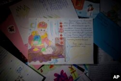 A letter by Marko Soroka to St. Nicholas sits with others in Izium, Ukraine, Dec. 6, 2024.