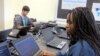 FILE - In this March 13, 2019, photo, Bennett High School students work on laptops in a school computer lab in Buffalo, N.Y.