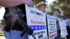 FILE - In this undated photo, gun rights supporters rally in Phoenix, Arizona. A U.S. appeals court on Thursday declared unconstitutional a federal law making it a crime for people under domestic violence restraining orders to own firearms.