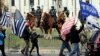 Members of the Albany police department mounted unit offer a police presence as gun rights activists with the National Constitutional Coalition of Patriotic Americans take part in a national rally aimed at pushing back against calls for stronger gun control measures outside the state Capitol, April 14, 2018, in Albany, New York.