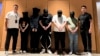 FILE - In this photo released by Xinhua News Agency, Myanmar police hand over five telecom and internet fraud suspects to Chinese police at Yangon International Airport in Yangon, Myanmar, Aug. 26, 2023. 