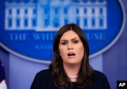 FILE - White House press secretary Sarah Huckabee Sanders talks to reporters during a press briefing in the Brady press briefing room at the White House, in Washington, Jan. 11, 2018.