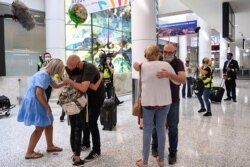 People reunite at Sydney Airport in the wake of COVID-19 border restrictions easing, with fully vaccinated Australians being allowed into Sydney from overseas without quarantine for the first time since March 2020, in Sydney, Nov. 1, 2021.