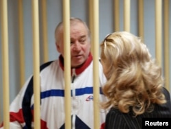 Sergei Skripal, a former colonel of Russia's GRU military intelligence service, looks on inside the defendants' cage as he attends a hearing at the Moscow military district court, Russia, Aug. 9, 2006.