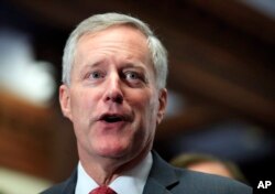 FILE - Freedom Caucus Chairman Rep. Mark Meadows, R-S.C., speaks to reporters on Capitol Hill in Washington. Divisions over whether to provide a conduit to citizenship for young “Dreamer” immigrants brought to the U.S. illegally loom as the pivotal sticking point.