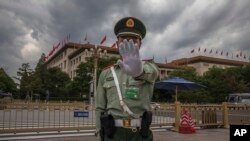 资料照：中国武警士兵做出禁止给北京人大会堂拍照的手式 。（2020年5月25日）