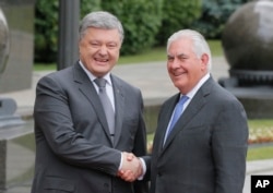 Ukrainian President Petro Poroshenko, left, and U.S. Secretary of State Rex Tillerson shakes hands before a meeting in Kyiv, July 9, 2017.