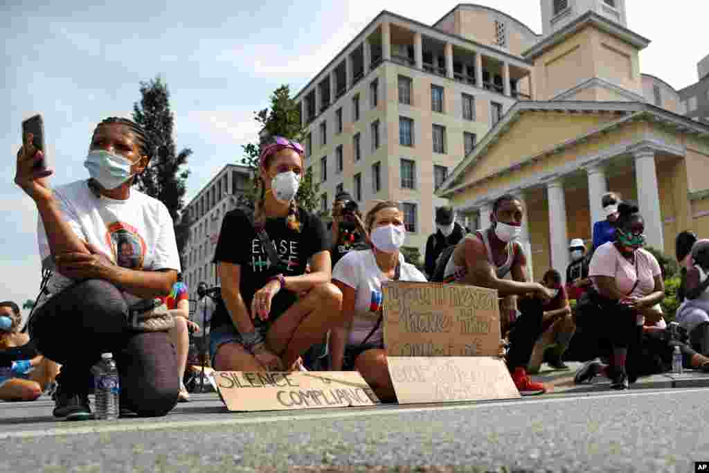 People kneel in silence, June 6, 2020, in Washington, in remembrance of George Floyd, who died after being restrained by Minneapolis police officers. 