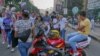 FILE - A group of young men make loud jokes while three girls walk by them in Cairo, Egypt, June 15, 2018. (Hamada Elrasam/VOA) 