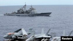 Armada jet tempur AS parkir di dek kapal induk USS George Washington, saat kapal USS Cowpens melintas di Laut China Selatan, September 2010 (Foto: dok).
