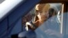 Libyan leader Moammar Gadhafi about to get into a car in Tripoli, Libya, Sunday, April 10, 2011. 