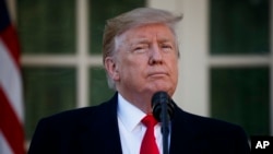 FILE - President Donald Trump announces a deal to temporarily reopen the government, in the Rose Garden of the White House, Jan. 25, 2019, in Washington. 