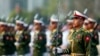 FILE - Myanmar soldiers parade during a ceremony to mark the 69th anniversary of Union Day in Naypyitaw, Myanmar. Kyaw Swa Naing and editor Kyaw Min Swe were arrested in June after a military officer filed a complaint against them. 