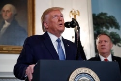 President Donald Trump, accompanied by Secretary of State Mike Pompeo, speaks in the Diplomatic Room of the White House in Washington, Oct. 23, 2019.