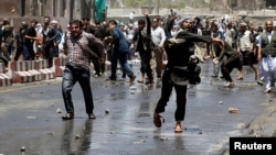 Afghans throw stones towards security forces during a protest in the wake of a deadly bombing Wednesday, in Kabul, Afghanistan, June, 2, 2017. 