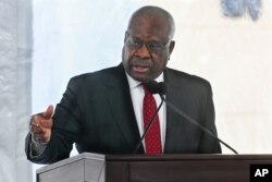 FILE - Supreme Court Justice Clarence Thomas delivers a speech in Atlanta, Feb. 11, 2020.