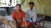 Keo Eat, 52, a deputy Prey Khla commune chief, decided to join the ruling Cambodian People’s Party after being served with a court summons shortly before the deadline to defect. He had been accused of incitement and faced the possibility of going to jail for two years if found guilty. He's shown with his wife, Keo Sarin. (Sun Narin/VOA Khmer)