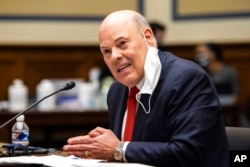 FILE - United States Postal Service Postmaster General Louis DeJoy speaks on Capitol Hill, Feb. 24, 2021.