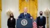 President Joe Biden speaks about the evacuation of American citizens, their families, SIV applicants and vulnerable Afghans in the East Room of the White House, Friday, Aug. 20, 2021, in Washington. Vice President Kamala Harris, left, and Secretary of State Antony Blinken, right,