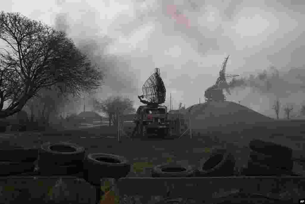 Smoke rise from an air defense base in the aftermath of an apparent Russian strike in Mariupol, Ukraine, Feb. 24, 2022.