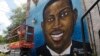 FILE - This May 17, 2020, photo shows a mural depicting Ahmaud Arbery in Brunswick, Ga.