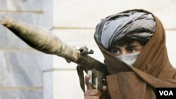 Seorang pemberontak Taliban sedang mengarahkan senjata roket. Palang Merah Internasional mencatat bahwa warga sipil di Afghanistan sering terjebak dalam pertempuran antara pasukan keamanan dengan pemberontak.