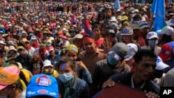 Cambodian's opposition party supporters gather during their party continuing of its mass demonstration at Democracy Square, in Phnom Penh, Cambodia, Sunday, Dec. 29, 2013. Several thousand garment workers pressing for higher wages joined opposition activists in protests, adding to pressure on Prime Minister Hun Sen. The workers are demanding a two-fold increase in the minimum wage to $160. (AP Photo/Heng Sinith) 