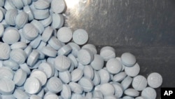 FILE - This photo provided by the U.S. Attorney's Office for Utah shows fentanyl-laced fake oxycodone pills collected during an investigation.
