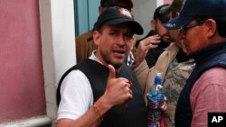 FILE - Opposition leader Luis Fernando Camacho gives a thumbs up outside the presidential palace in La Paz, Bolivia, after President Evo Morales announced his resignation to the presidency on Nov. 10, 2019.