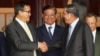 Cambodian Prime Minister Hun Sen, left, shakes hands with opposition party leader Sam Rainsy, right, after a meeting, as Sar Kheng, center, deputy prime minister, looks on at the National Assembly in Phnom Penh, Cambodia, Monday, Sept. 16, 2013.