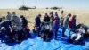 Astronaut AS Andrew Morgan (kiri), Jessica Meir (kanan), dan kosmonaut Rusia Oleg Skripochka duduk sesaat setelah mendarat dengan kapsul ruang angkasa Soyuz MS-15 dekat Dzhezkazgan, Kazakhstan, 17 April 2020.