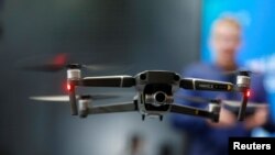 FILE - A Chinese-made DJI Mavic 2 Zoom flies in a netted area during the 2019 CES in Las Vegas, Nevada, Jan. 9, 2019.